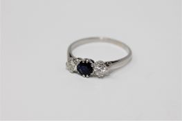 A platinum sapphire and diamond three stone ring