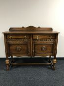 A carved oak double door sideboard CONDITION REPORT: In very good, clean condition.