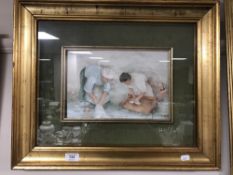 A gilt framed oil on board depicting figures washing clothes by a river,
