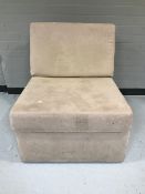 A folding bed chair in beige fabric