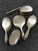 A four piece sterling silver backed dressing table brush set together with a pair of sterling