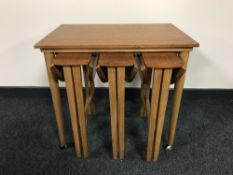 A nest of four teak tables