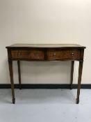 An inlaid mahogany Regency style serpentine fronted side side table fitted two drawers