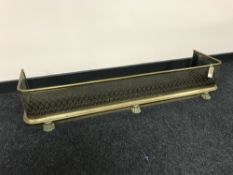 A brass fire curb on paw feet