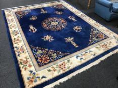 A fringed Chinese embossed carpet on blue ground