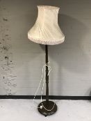 An oak d-shaped hall table and a standard lamp