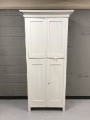 An early twentieth century painted pine double cupboard