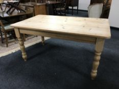 A pine farmhouse kitchen table CONDITION REPORT: Minor surface scuffs and scratches