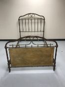 A painted cast iron and brass 4' bed frame