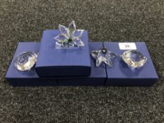 Four boxed Swarovski Crystal figures; a star fish, clam, seashell and an orchid.