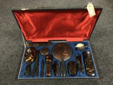 A twelve piece tortoise shell dressing table set in a fitted box together with a horn cased