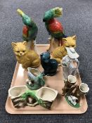 A tray containing pottery cat ornaments, Fowler ware vases, a pair of German parakeet figures,