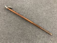 A walking cane with silver pommel