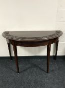 A Victorian carved inlaid mahogany D shaped table