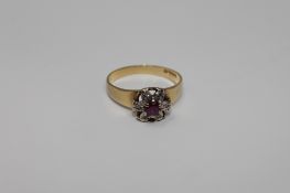 An 18ct gold ruby and diamond cluster ring, size K/L, 2.6g.