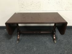 An inlaid mahogany Strongbow drop leaf coffee table on brass feet