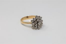 An 18ct gold diamond cluster ring set with 19 brilliant cut stones,