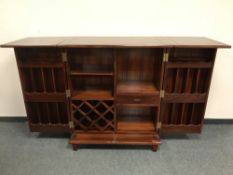 An oriental hardwood concertina cocktail cabinet, extended width 192.