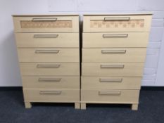A pair of contemporary beech six drawer chests