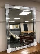 A contemporary all glass mirror, 110 cm x 141 cm.