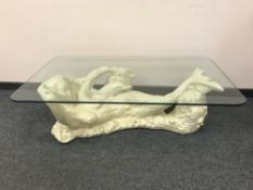 An ornate 'Mermaid' glass topped coffee table, 127 cm x 76 cm.