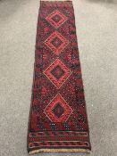 A Meshwani runner on red ground,