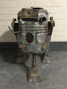 A metal garden burner in the form of R2-D2