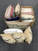 Three boxes containing thirteen assorted cushions