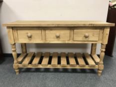 A reclaimed pine three drawer side table,