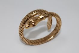 An 18ct gold snake bracelet with ruby eyes, 36.8g gross.