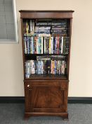 A set of inlaid mahogany Bradley bookshelves containing a large quantity of DVD's and boxsets