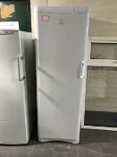 An Indesit upright fridge