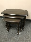 A nest of Ercol dark elm tables