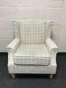 A wing back chair upholstered in beige
