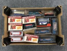 A box containing approximately fourteen die cast buses,