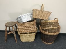 An antique pine stool together with six assorted wicker hand and log baskets