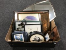 A box containing assorted framed pictures, wooden panel,