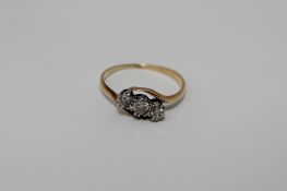 An early twentieth century diamond three stone ring, approximately 0.25ct, size o/p, 2.3g.
