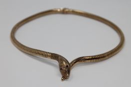 A 9ct gold snake necklace with ruby eyes, 27.1g gross.