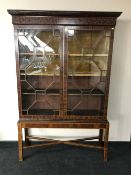 A Victorian inlaid mahogany double door bookcase on stand CONDITION REPORT: This