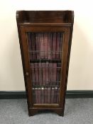 An early twentieth century mahogany glazed cabinet containing a set of 1911 Encyclopaedia