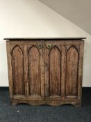 An oak Gothic vestment cabinet fitted with five trays