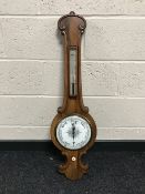 A walnut banjo barometer with enamelled dial