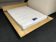 A contemporary low beach bed frame with leather headboard,