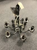 A metal six way light fitting with tulip decoration