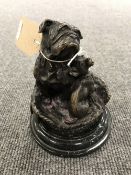 A bronze figure of a bulldog with a Chihuahua on marble base