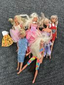 A box containing six twentieth century Barbie dolls with clothes