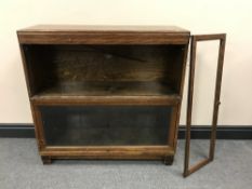 An oak twin section Globe Wernicke stacking bookcase (top shelf lacking glass)
