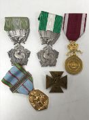 Four French medals with ribbons together with an early twentieth century French badge