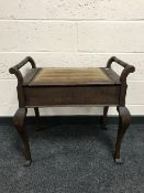 An early twentieth century oversized storage piano stool together with a plant stand